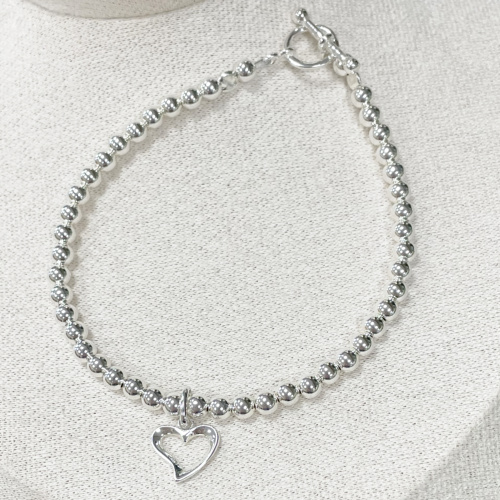 Sterling silver bracelet with 4mm beads and open-heart charm