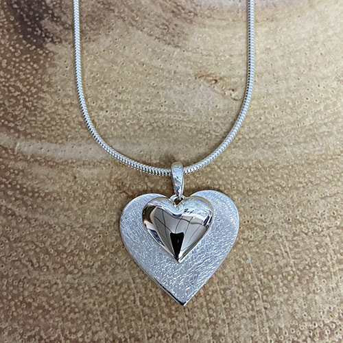 Sterling silver solid double heart pendant on a silver chain
