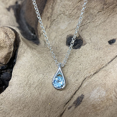 Silver teardrop pendant with blue topaz