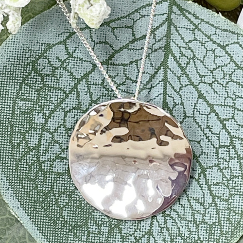 Silver circular hammered pendant