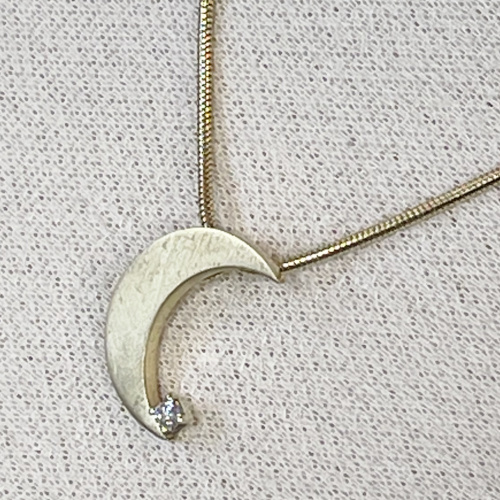 Yellow gold moon shaped diamond pendant