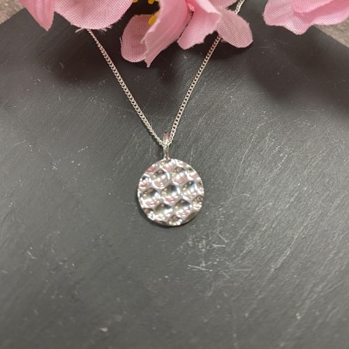 Silver circular hammered pendant